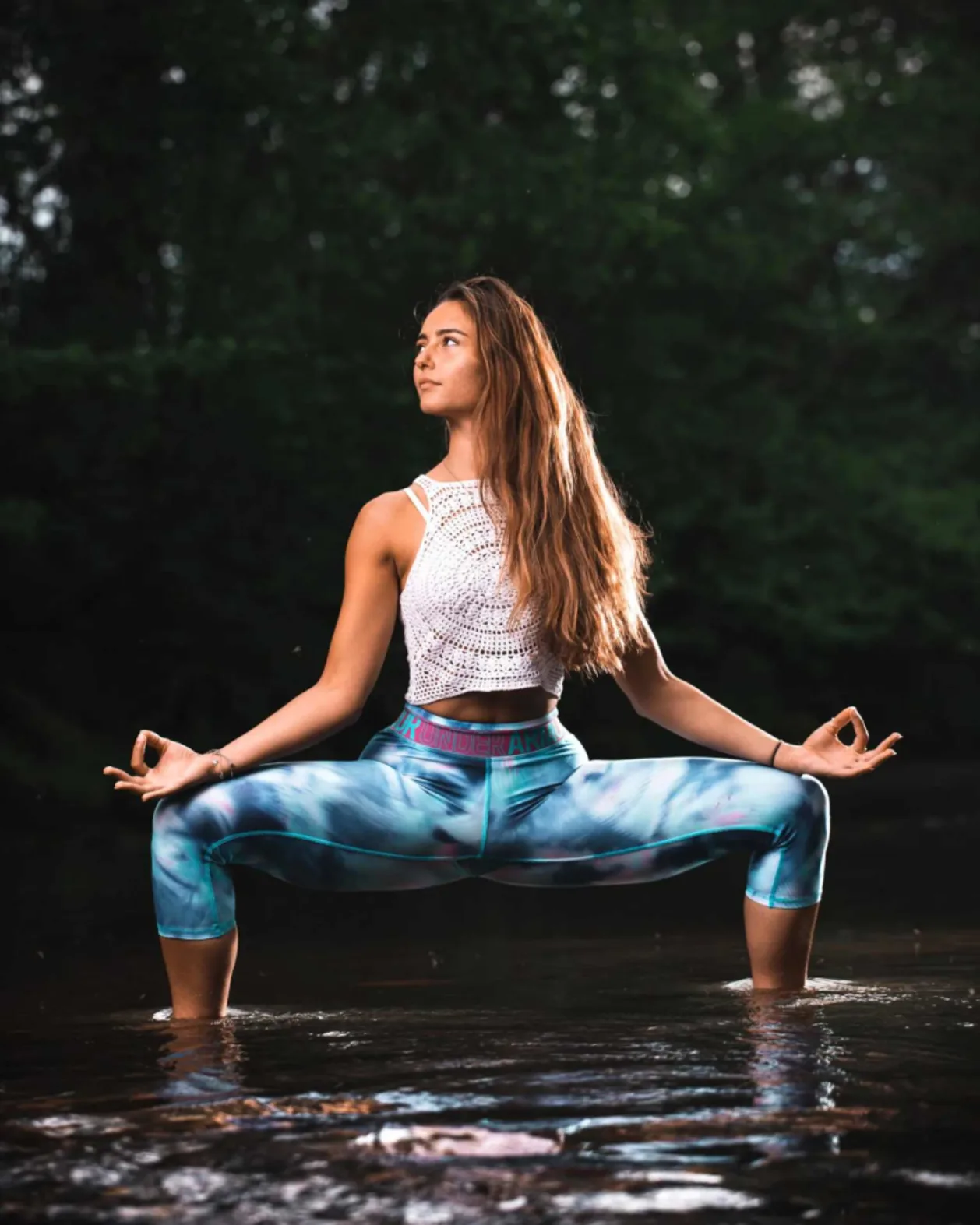 woman in goddess pose wearing athleisure wear